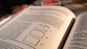 Open book on magic tricks with diagrams, related to Annemann's life and legendary magic performances.