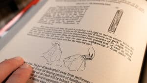 Close-up of a vintage magic trick instruction page with illustrations.