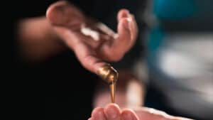Close-up of a hand performing the Liquify magic trick with flowing liquid.