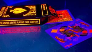 Vibrant Bicycle neon solar-orange rider playing cards on a reflective surface. Perfect for magic tri.