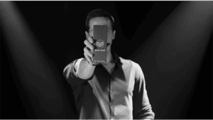 Performer holding Dual Pad magic trick device in front of camera.