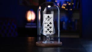 Rising card illusion under glass with playing cards for magic tricks.