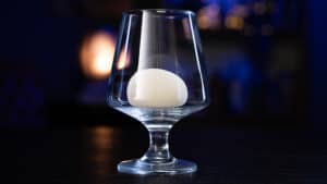 Rising card illusion inside a glass for magic performances.