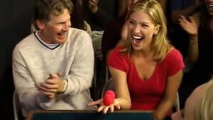 Performing WGM Sponge Balls magic trick with audience laughter.