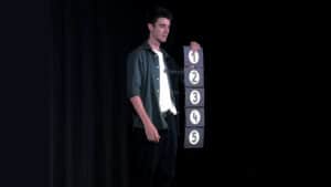 Magician performing Prestige Pro parlor magic trick with numbered panel.