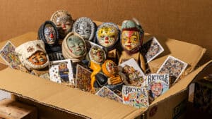 Colorful Reen Barrera masks with playing cards for magic tricks.