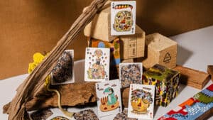 Close-up of colorful playing cards with artistic designs on a wooden surface.