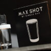 Max Shot magic trick by Sinbad Max and Ochiu, performing a stunning illusion with a glass container.