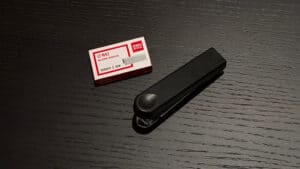 Stapled Fusion magic trick device for illusions and card magic performances.