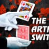 Close-up of a magician performing The Artful Switch card trick with red and black cards.