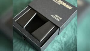 The QuickDraw Pro magic trick device in its packaging for easy use and transport.