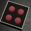 Bright pink crochet balls for magic tricks and illusions. Perfect for magicians and performers.
