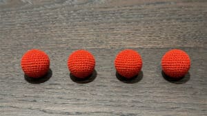 Bright red crochet balls for magic tricks and illusions. Perfect for close-up magic performances and.