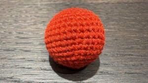 Red crochet ball for magic tricks and illusions. Perfect for close-up magic performances and captiva.