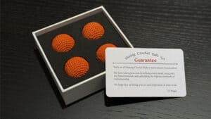 Bright orange crochet balls for magic tricks and illusions. Perfect for magicians seeking vibrant, h.