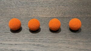 Orange crochet balls for magic tricks and illusions. Perfect for close-up magic performances and cap.