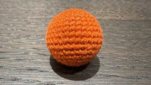 Orange crochet ball for magic tricks and illusions. Perfect for close-up magic performances and capt.