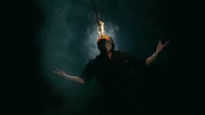 Performer creating a fiery illusion during a magic show.