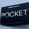 Close-up of the blue magic trick box titled "Pocket" by Marco Markiewicz on snowy surface.