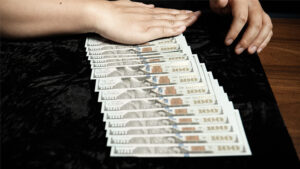 Close-up of a black art magic pad with hundred-dollar bills for magic tricks.
