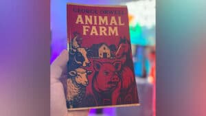 Cover of Animal Farm by George Orwell, featured in a magic trick demonstration.