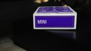 Purple mini bicycle playing cards in a box for magic tricks and card illusions.