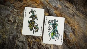 Mortalis Machina cobalt playing cards featuring intricate joker and queen designs.