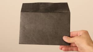 Envelope stage magic trick with a black envelope for illusions and card tricks.