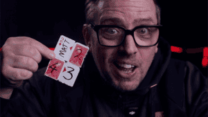 Magician performing card trick with Reform 52 deck for magic illusion.