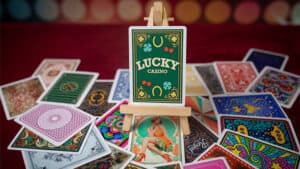 Lucky 52 card game setup with colorful playing cards on a red table.
