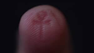 Close-up of a finger with a mysterious mark, inspired by magical illusions.