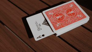 Up of WAKEN PRO magic card trick setup on wooden surface.