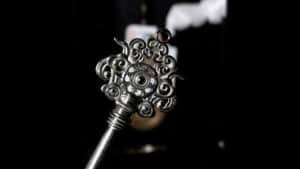 Silver cloud-shaped key with intricate swirls and mystical design.