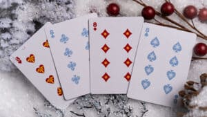 Set of Christmas-themed playing cards featuring snowman design for holiday magic tricks.