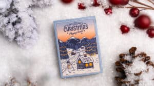 Festive Christmas playing cards featuring snow-covered mountains and holiday scene.