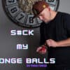 Performer demonstrating sponge ball magic trick with red sponge balls.