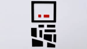 Tangram puzzle pieces forming a minimalist face design for brain teaser fun.