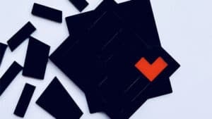 Tangram Paradox Mini puzzle with black and orange pieces for optical illusion and brain teaser.