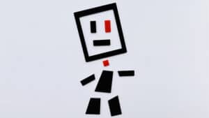 Tangram Paradox Mini figure made of black and red geometric shapes on white background.