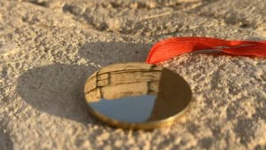 Close-up of the Bronze Enigma coin used in magic tricks by Jackie Zhao and JT Magic.