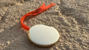 Bronze Enigma coin performing a magic trick on textured surface.