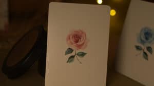 Elegant flower-themed playing cards with rose design for magic tricks.