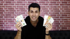Kid performing paper to money magic trick with colorful bills.