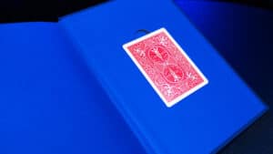 Close-up of a playing card on a blue magic prop for card tricks.