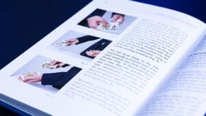 Close-up of a book page showing magic tricks with images and text.