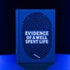 Cover of "Evidence of a Well Spent Life" by Helge Thun, blue fingerprint design.