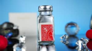 Close-up of a glass jar with a playing card for the Chop Pot magic trick.