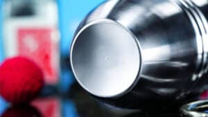 Close-up of a shiny metal cup used in the Chop Pot magic trick.