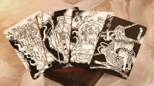 Mythic Divide (Fury of Light) tarot-style playing cards featuring mystical characters and vibrant ar.