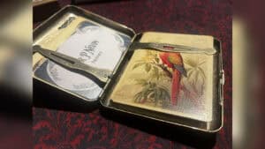 Close-up of the Papilio Experiment magic trick with a colorful bird illustration.